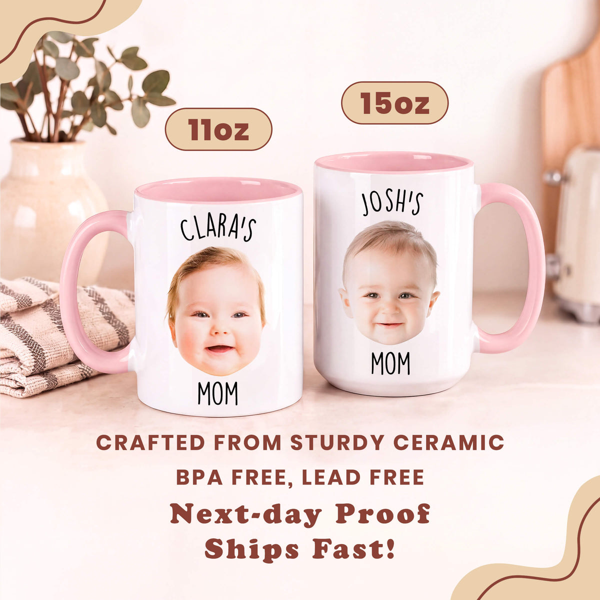 Two personalized ceramic mugs with pink handles and interiors, shown side by side on a light beige tabletop. The left mug is labeled 11oz and features the photo of a baby with the text 'CLARA'S MOM'; the right mug is labeled 15oz and features a baby photo with the text 'JOSH'S MOM'.